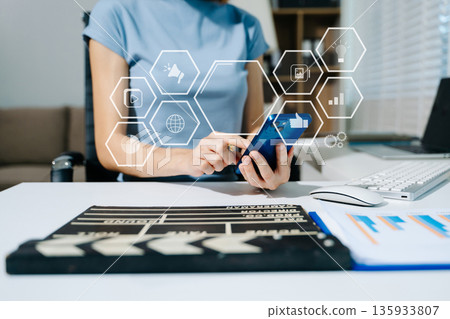 Creative woman using clapperboard in modern office studio, perfect for film production, video content, and cinematic storytelling concepts. Creative woman using clapperboard in modern office studio, perfect for film production, video content, and cinematic storytelling concepts. 135933807
