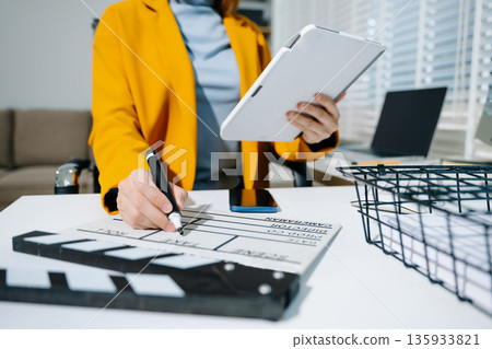 Businesswoman in yellow blazer planning strategy with charts and reports, perfect for corporate, teamwork, and office productivity concepts. Businesswoman in yellow blazer planning strategy with charts and reports, perfect for corporate, teamwork, and office productivity concepts. 135933821