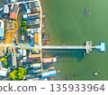 Aerial view top view of the fisherman village with fishing boats and house roof at the pier in Phangnga Thailand, Panorama high angle view 135933964