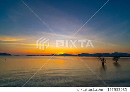 Landscape view of majestic clouds in the sky sunset or sunrise over sea with reflection in the tropical sea,Beautiful cloudscape scenery,Amazing light of nature Landscape nature background 135933985