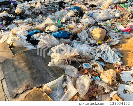 Large pile of plastic waste and garbage bags at an open dumpsite, highlighting plastic pollution, environmental damage, waste management problems, recycling crisis, sustainability issues, and global e Large pile of plastic waste and garbage bags at an open dumpsite, highlighting plastic pollution, environmental damage, waste management problems, recycling crisis, sustainability issues, and global e 135934132