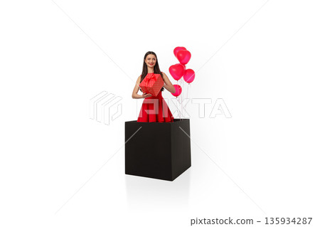 Woman in red dress holds gift in black box, isolated, PNG Woman in red dress holds gift in black box, isolated, PNG 135934287
