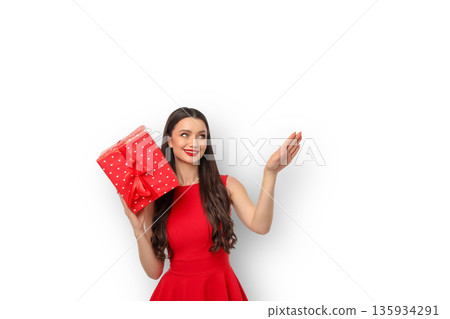 Woman in red dress holds a gift and smiles while posing, isolated, PNG 135934291
