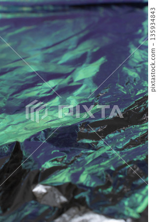 Dark crumpled metallic foil abstract background 135934843