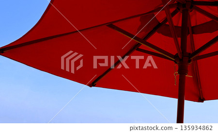 Clear blue sky and red parasol 135934862