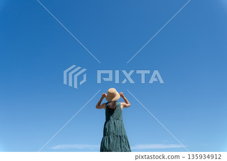 A woman walking along the beach 135934912