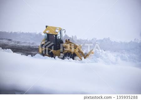 除雪車正在清理積雪覆蓋的停車場 135935288
