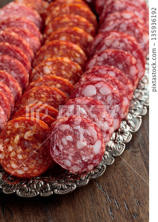 Smoked sausages on a silver tray. 135936192