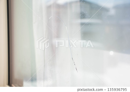 Cracks in window glass - an image of housing trouble Cracks in window glass - an image of housing trouble 135936795