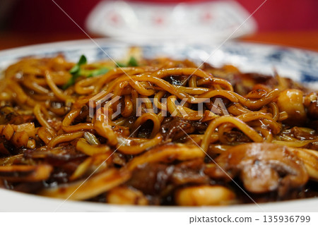 Delicious Korean-style Chinese seafood Jajangmyeon (black bean sauce noodles) served on a platter at a restaurant Delicious Korean-style Chinese seafood Jajangmyeon (black bean sauce noodles) served on a platter at a restaurant 135936799