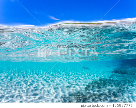 Partially submerged photograph of the white sand beaches of the Kerama Islands. Kahi Island and Amuro Island, beautiful coral reefs and schools of tropical fish. Kahi Island, Shimajiri District, Okinawa Prefecture 135937775