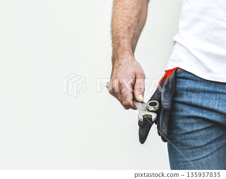 Attractive man and spanners. Studio shot Attractive man and spanners. Studio shot 135937835