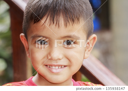 Closeup cute portrait of Asian little boy smiling outdoor 135938147