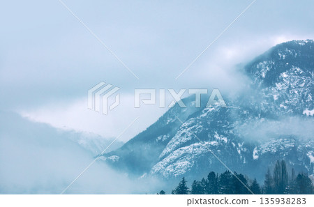 Fantastic view of the tops of the mountain ridge above the clouds Fantastic view of the tops of the mountain ridge above the clouds 135938283