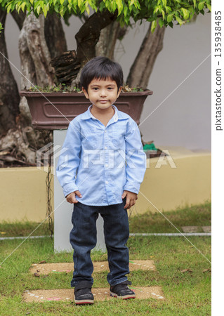 Portrait of cute happy Asian little boy standing in park Portrait of cute happy Asian little boy standing in park 135938485