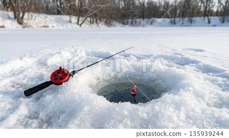 Ice Fishing Rod and Hole on Frozen Lake 135939244