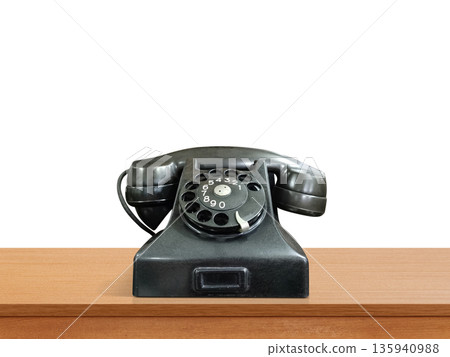Old black desktop telephone, antique phone placed on a wooden table. Old black desktop telephone, antique phone placed on a wooden table. 135940988