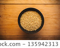 Brown rice in a bowl and a wooden table 135942313