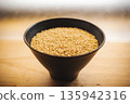 Brown rice in a bowl and a wooden table 135942316