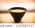 Brown rice in a bowl and a wooden table 135942317
