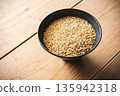 Brown rice in a bowl and a wooden table 135942318