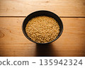 Brown rice in a bowl and a wooden table 135942324