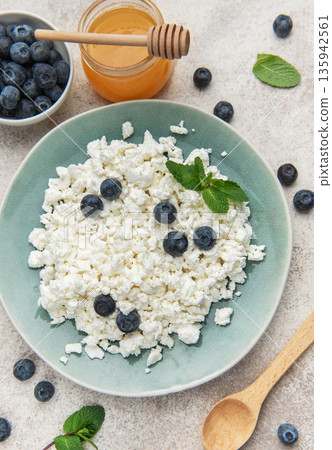 Cottage cheese with blueberries honey and mint healthy breakfast Cottage cheese with blueberries honey and mint healthy breakfast 135942561