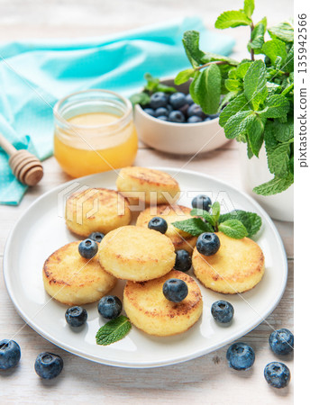 Cottage cheese pancakes with blueberries, honey, and mint Cottage cheese pancakes with blueberries, honey, and mint 135942566