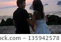 Romantic Couple Holding Hands at Sunset Over Tropical Sea In Summer Season 135942578
