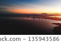 Danang aerial sunset over city sea and mountains skyline, Evening panorama Da Nang coast city lights golden hour bay 135943586