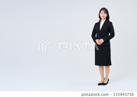 A woman in a suit and a white background 135943738