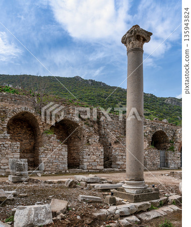 Ancient Corinthian column and stone ruins at the archaeological site of Ephesus, Selcuk, Turkey. Ancient Corinthian column and stone ruins at the archaeological site of Ephesus, Selcuk, Turkey. 135943824