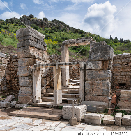 Ancient stone ruins of Ephesus with lush green hills, Selcuk, Turkey Ancient stone ruins of Ephesus with lush green hills, Selcuk, Turkey 135943831