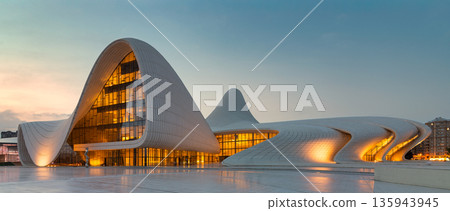 Illuminated Heydar Aliyev Center modern architecture at sunset Baku Azerbaijan Illuminated Heydar Aliyev Center modern architecture at sunset Baku Azerbaijan 135943945