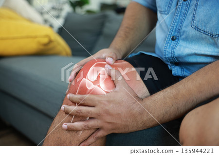 Close-up of hand holding painful injured knee with red inflamed spot and X-ray bone skeleton joint overlay. Medical concept of fracture, arthritis, tendonitis, or muscle ache in outdoor background. Close-up of hand holding painful injured knee with red inflamed spot and X-ray bone skeleton joint overlay. Medical concept of fracture, arthritis, tendonitis, or muscle ache in outdoor background. 135944221
