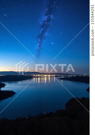 Lake and city lights under the starry sky 135944291