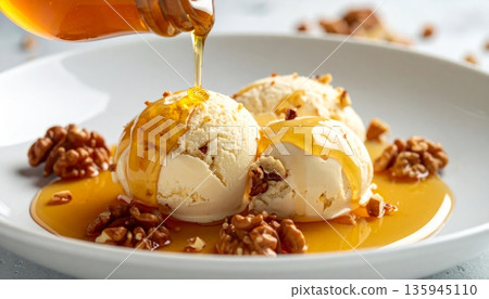 A delicious gourmet dessert of chocolate ice cream served in a white bowl with fresh chocolate sauce makes a sweet and healthy snack A delicious gourmet dessert of chocolate ice cream served in a white bowl with fresh chocolate sauce makes a sweet and healthy snack 135945110