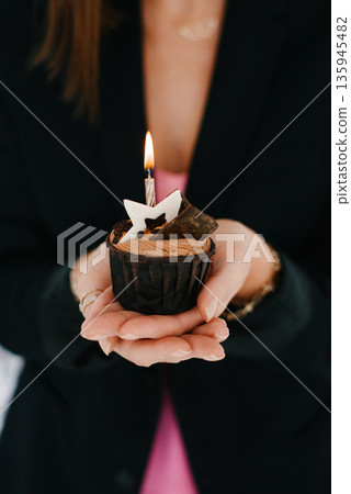 Cupcake With Candle In Female Hands 135945482