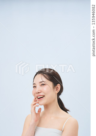 Young woman touching cheeks 135946082