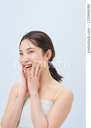 Young woman touching cheeks 135946086