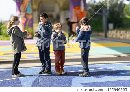 Children playing games together on colorful urban playground Children playing games together on colorful urban playground 135946265