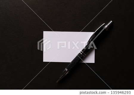 Ballpoint pen and notepad on a black background 135946293