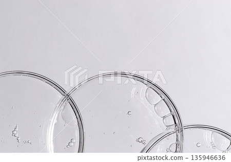 Liquid cosmetic product for the skin in a Petri dish. Copy space 135946636