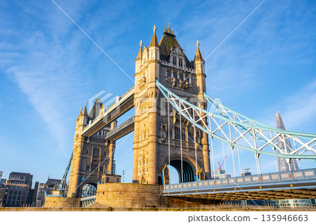 Tower Bridge stands majestically in the morning light, with clear skies and its iconic structure reflected in the Thames. A perfect start to a day in the heart of London. 135946663