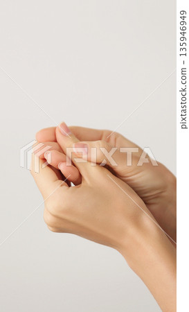 Vertical close-up of female hands with elegant manicures. Self-care, and beauty. Beauty Salon. Copy space 135946949