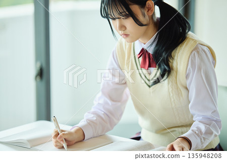 High school girls studying hard for exams High school girls studying hard for exams 135948208