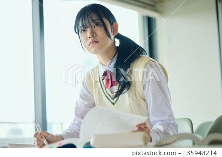 High school girls studying hard for exams High school girls studying hard for exams 135948214