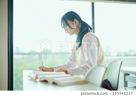 High school girls studying hard for exams High school girls studying hard for exams 135948217