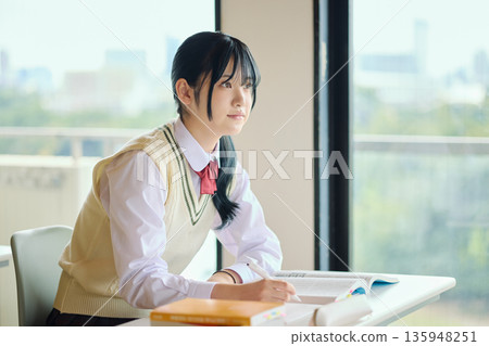 High school girls studying hard for exams High school girls studying hard for exams 135948251