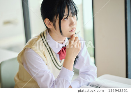High school girls studying hard for exams High school girls studying hard for exams 135948261